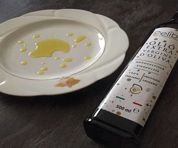 Organic Evo Oil in the dish and bottle of organic extra virgin olive oil monocultivar of sinopolese